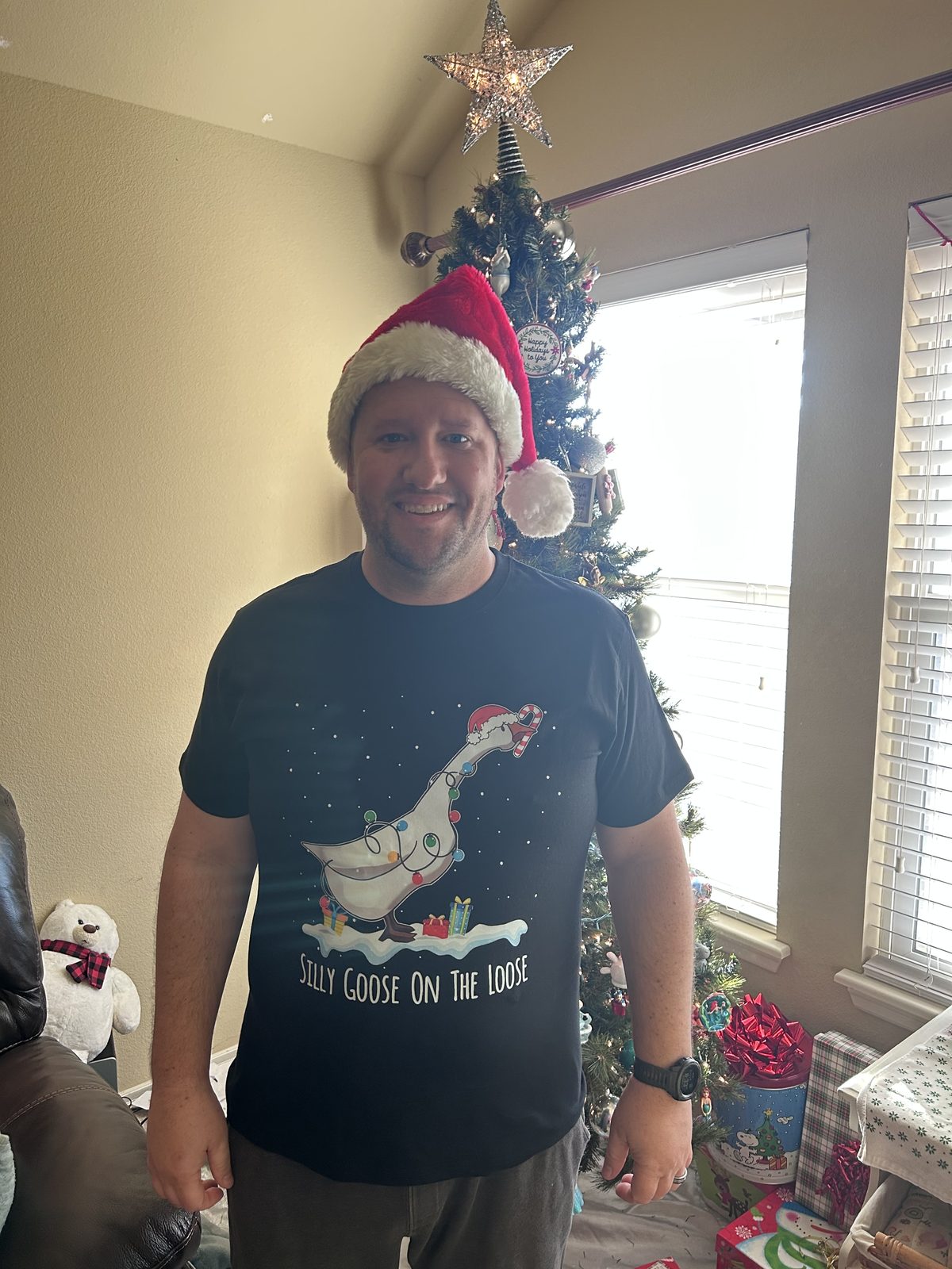 John at home in front of the Christmas tree